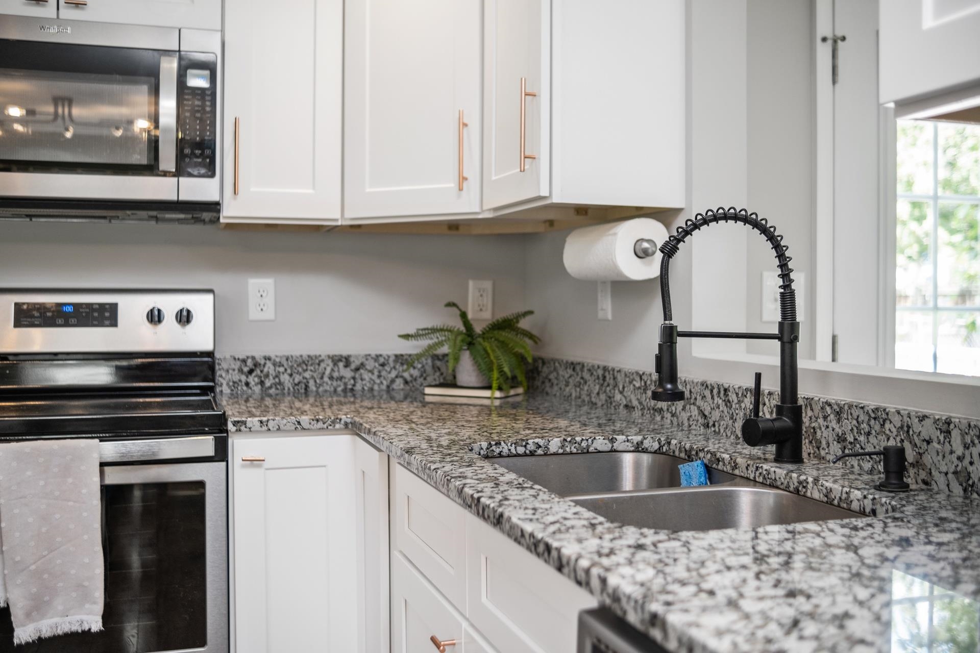 50 Valley Road Ruckersville, VA 22968 - Photo 3 of 39 a kitchen with granite countertop a sink a stove and cabinets