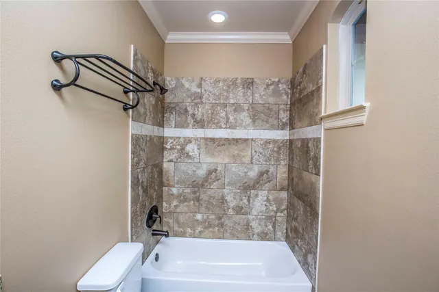 a bathroom with a granite countertop sink a toilet and a mirror