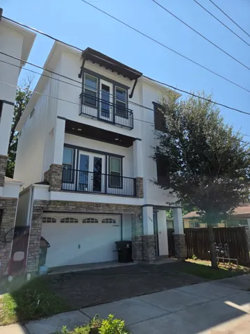 a front view of a building with a garden