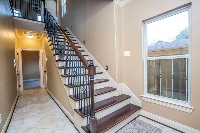 a living room with furniture kitchen view and a chandelier