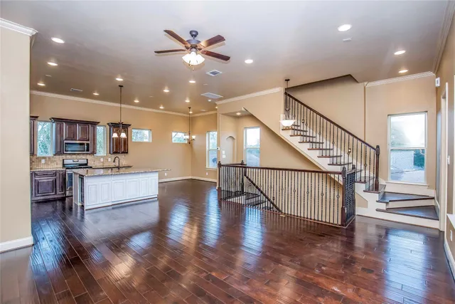 a large white kitchen with a large island oven a stove and white cabinets