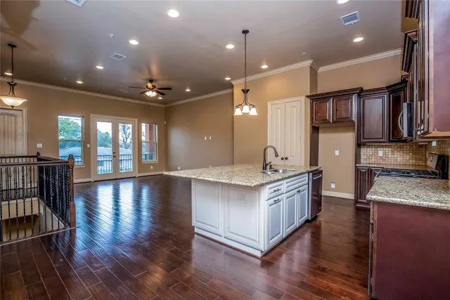 a bedroom with a large bed and a chandelier