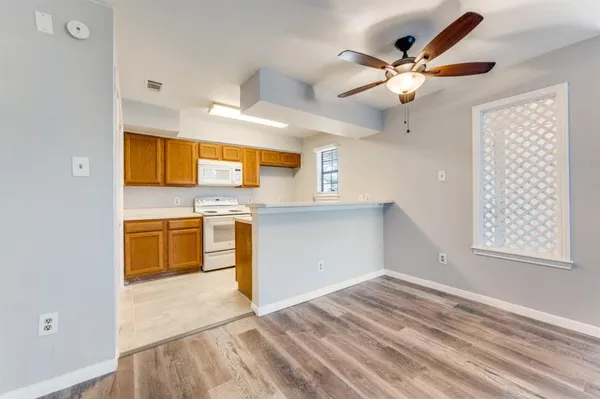 a kitchen with stainless steel appliances a stove a microwave and cabinets