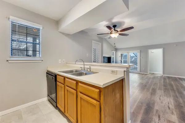 a kitchen with a sink appliances and cabinets