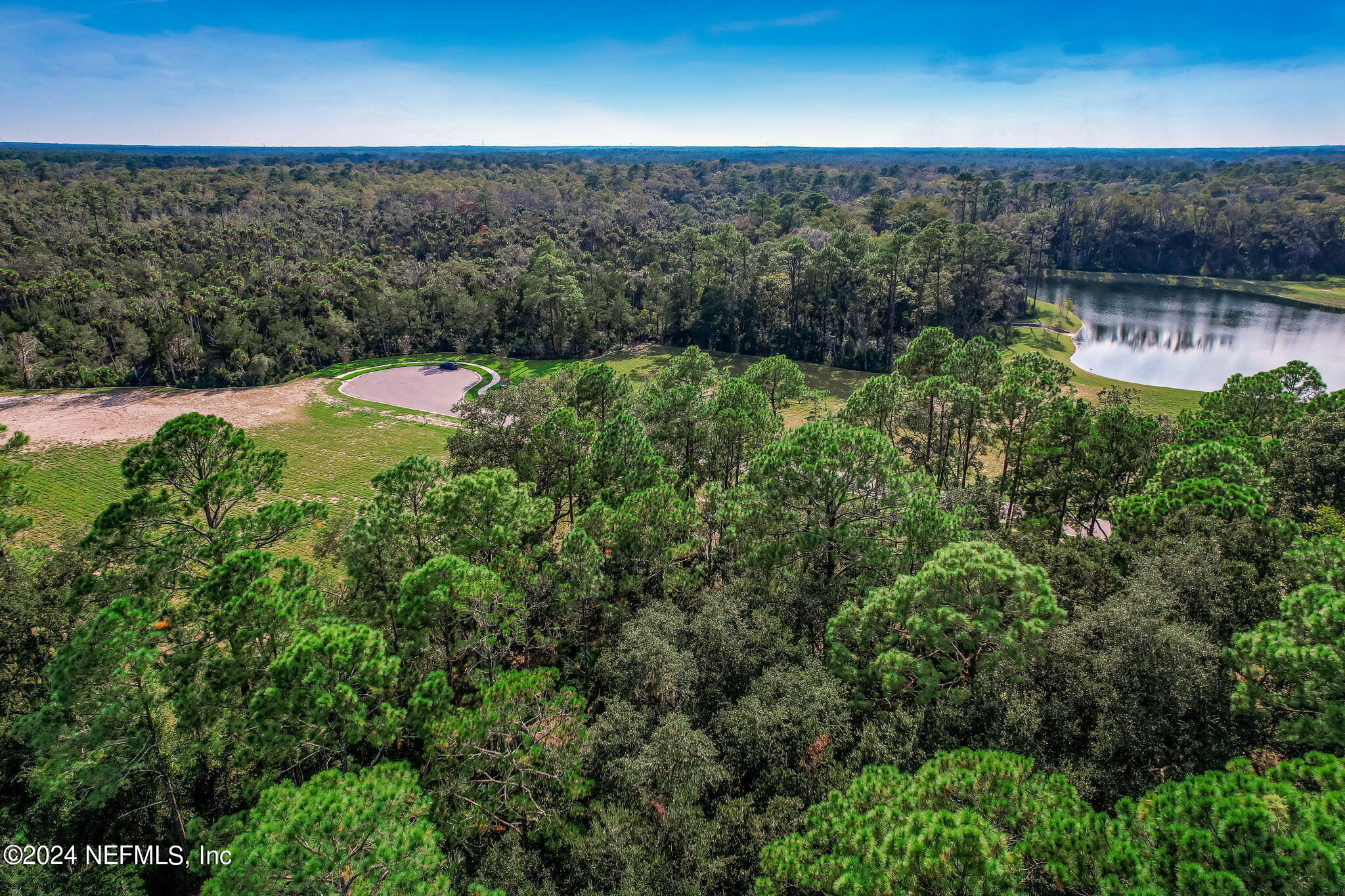 557 Shell Ridge Lane Ponte Vedra, FL 32081 - Photo 5 of 17 a view of a garden with a bench in it