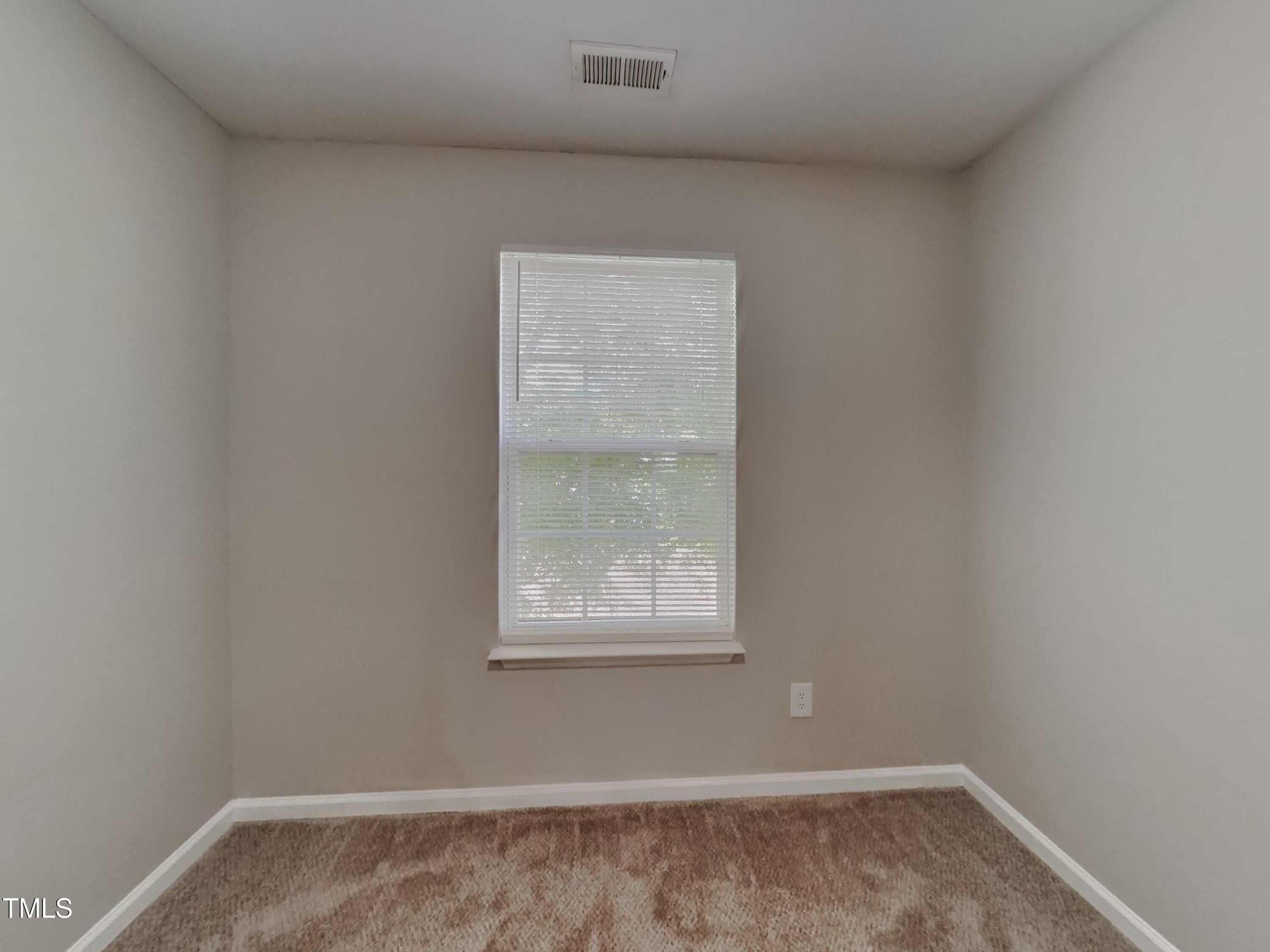5416 Neuse Forest Road Raleigh, NC 27616 - Photo 12 of 15 an empty room with a window