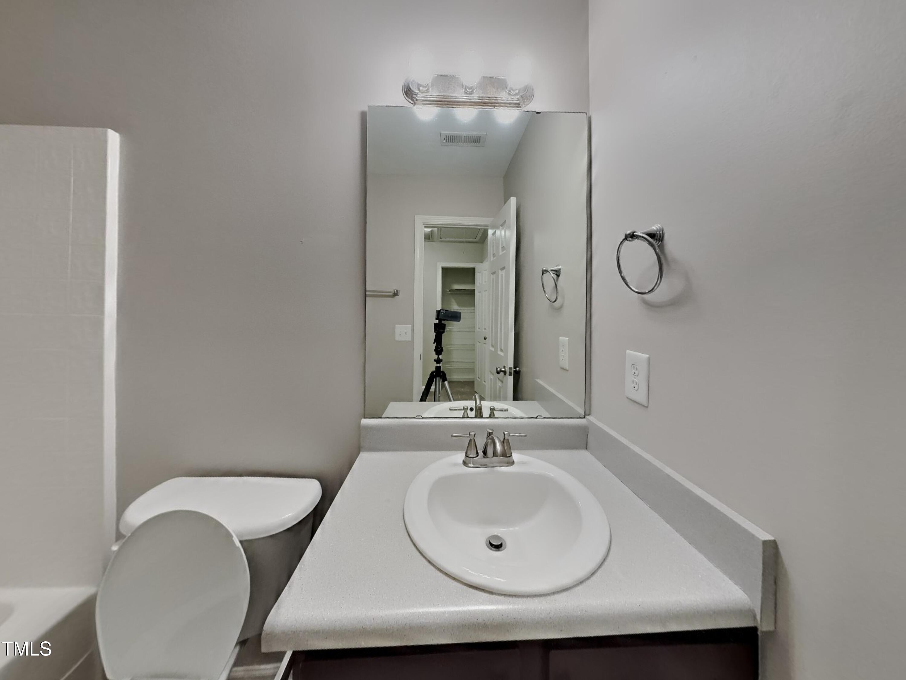 5416 Neuse Forest Road Raleigh, NC 27616 - Photo 13 of 15 a bathroom with a sink a mirror and a toilet