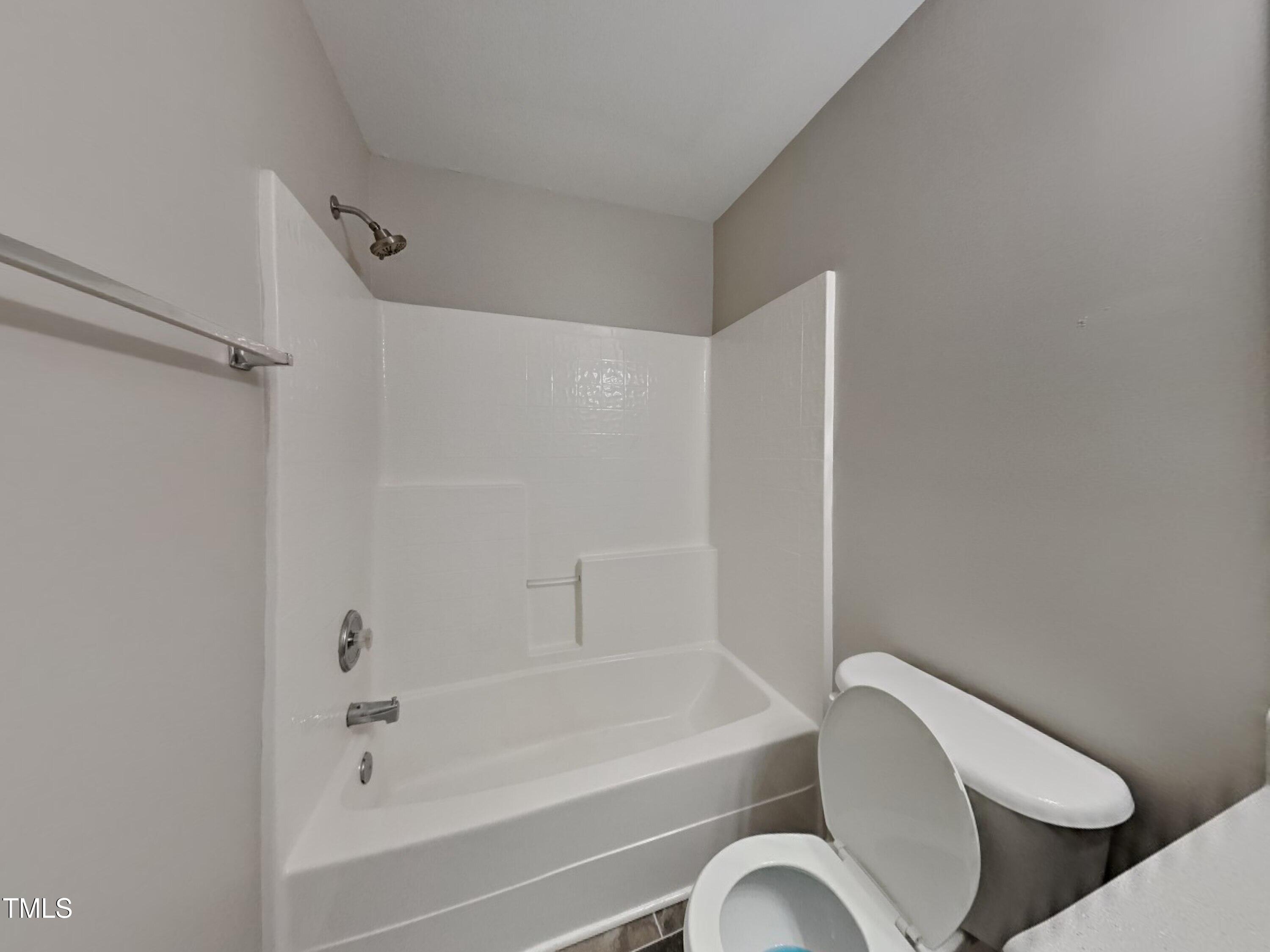 5416 Neuse Forest Road Raleigh, NC 27616 - Photo 14 of 15 a bathroom with a toilet and a bathtub