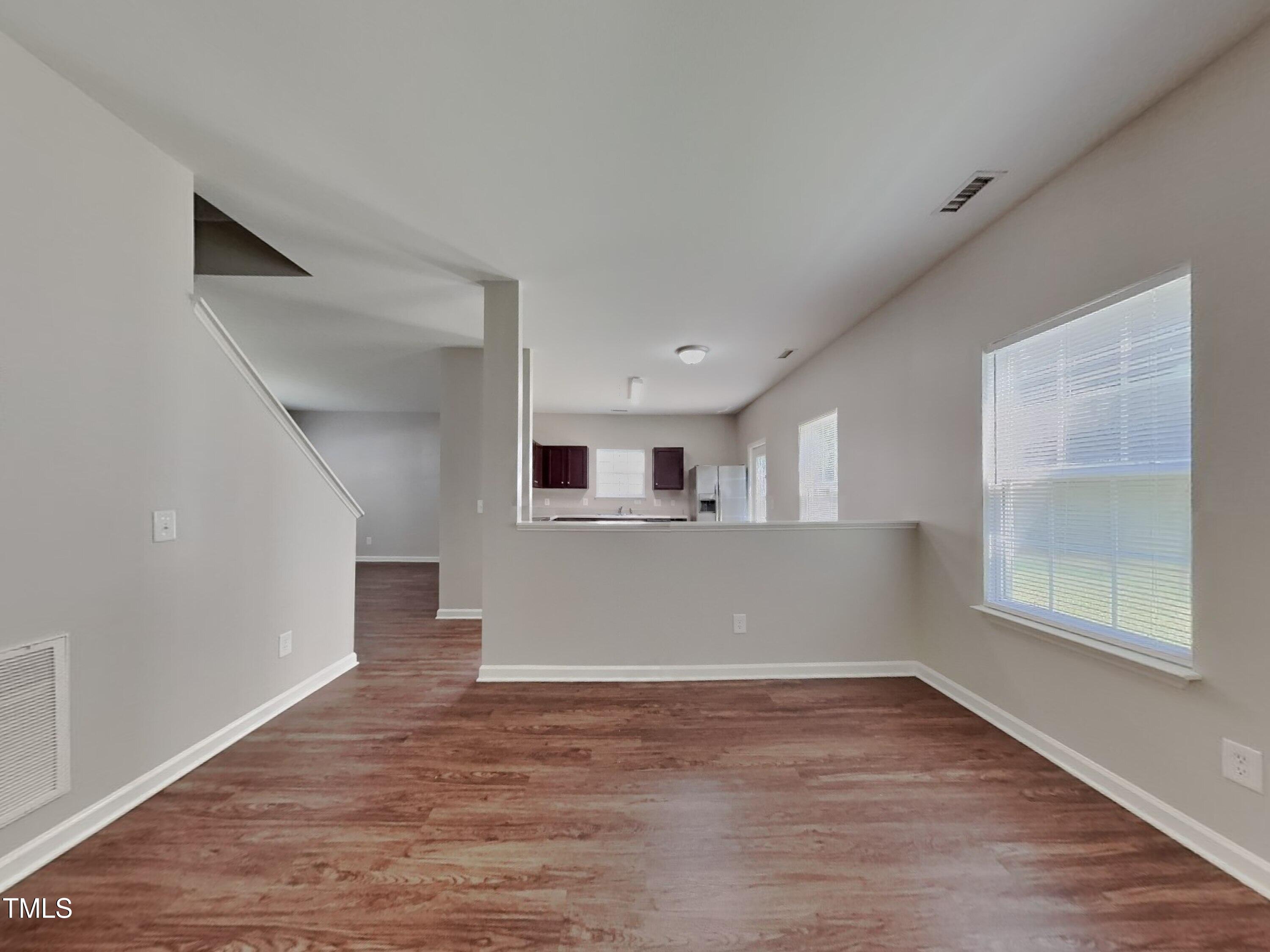 5416 Neuse Forest Road Raleigh, NC 27616 - Photo 2 of 15 a view of empty room with wooden floor and fan