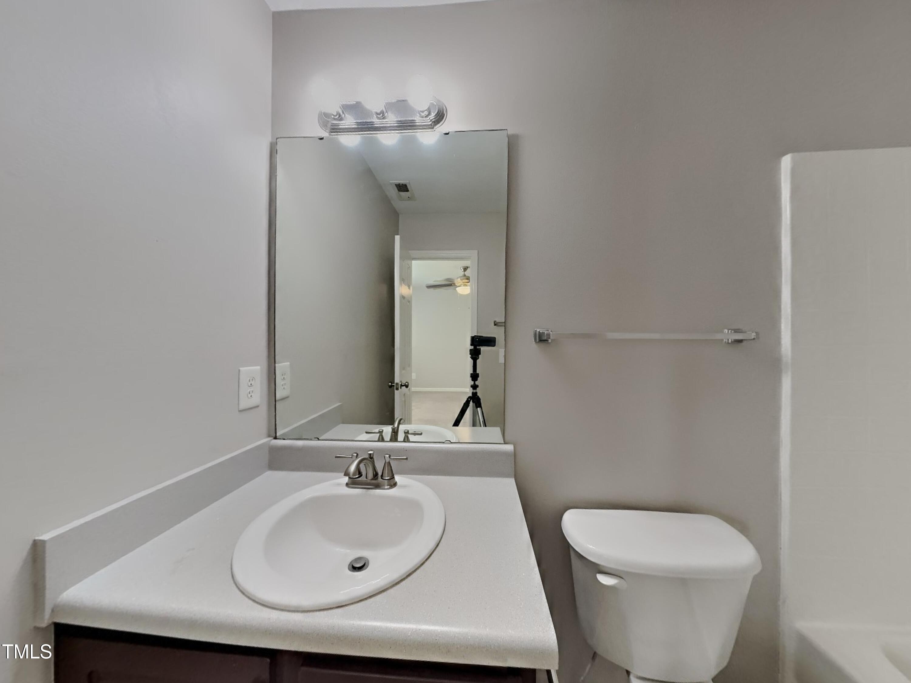5416 Neuse Forest Road Raleigh, NC 27616 - Photo 9 of 15 a bathroom with a toilet sink and mirror