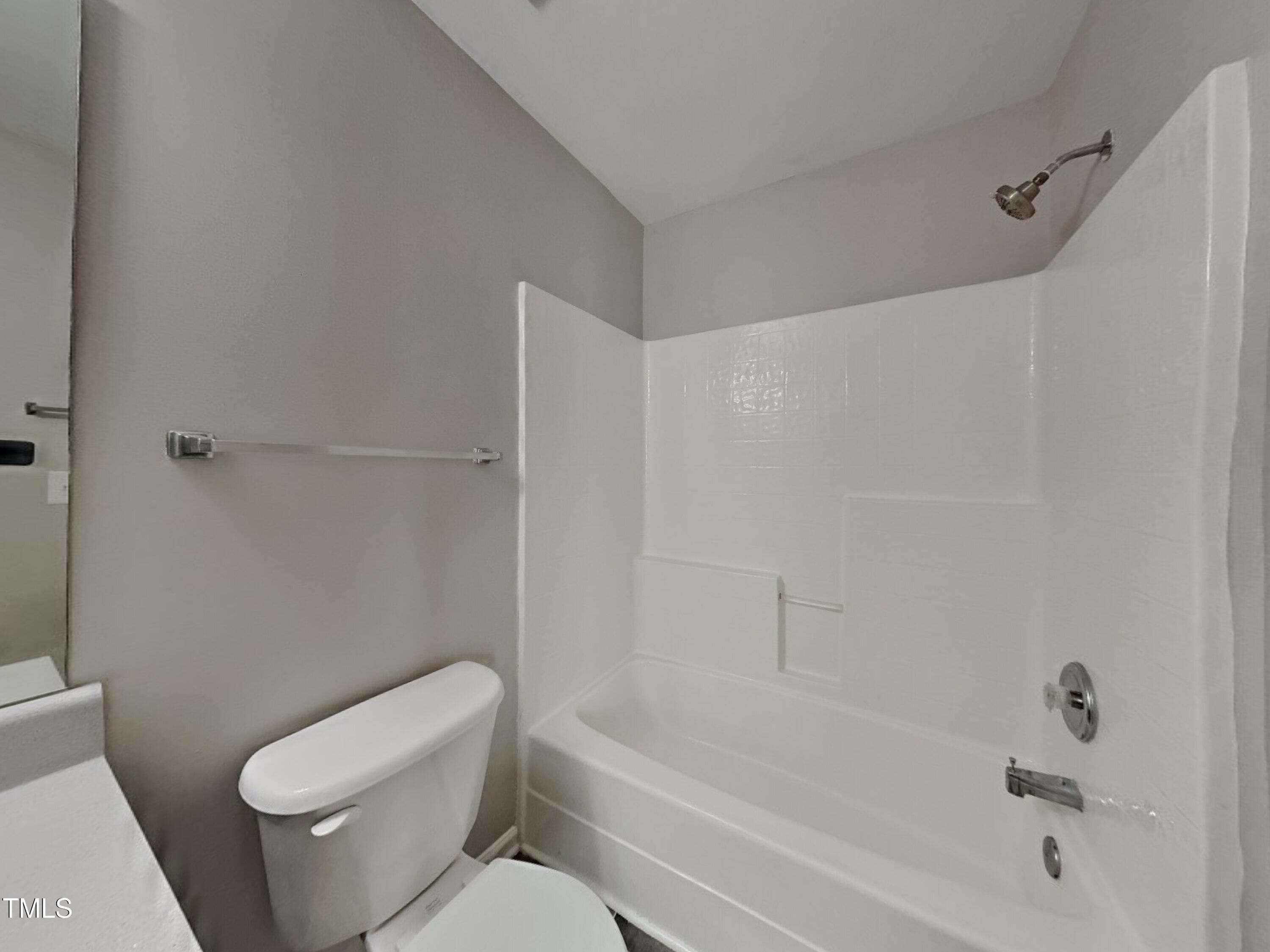 5416 Neuse Forest Road Raleigh, NC 27616 - Photo 10 of 15 a bathroom with a toilet and a bathtub