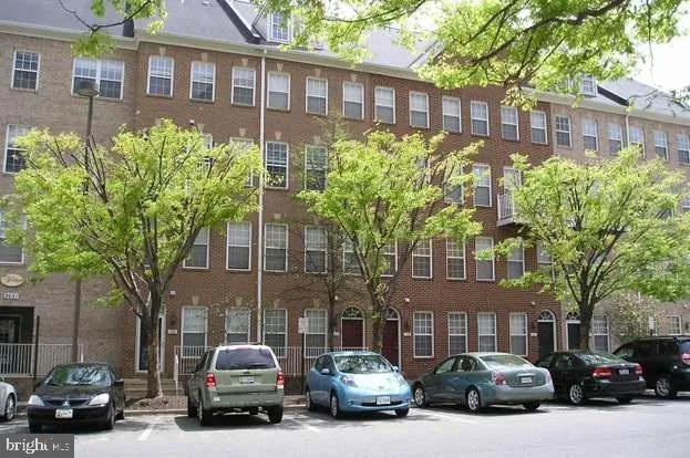 a couple of cars parked in front of a building