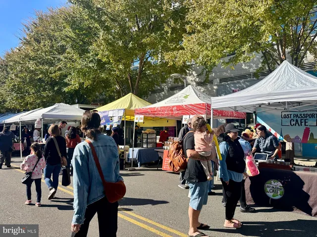 a group of people sitting in front of retail shop