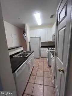 a kitchen with a stove a refrigerator and a sink