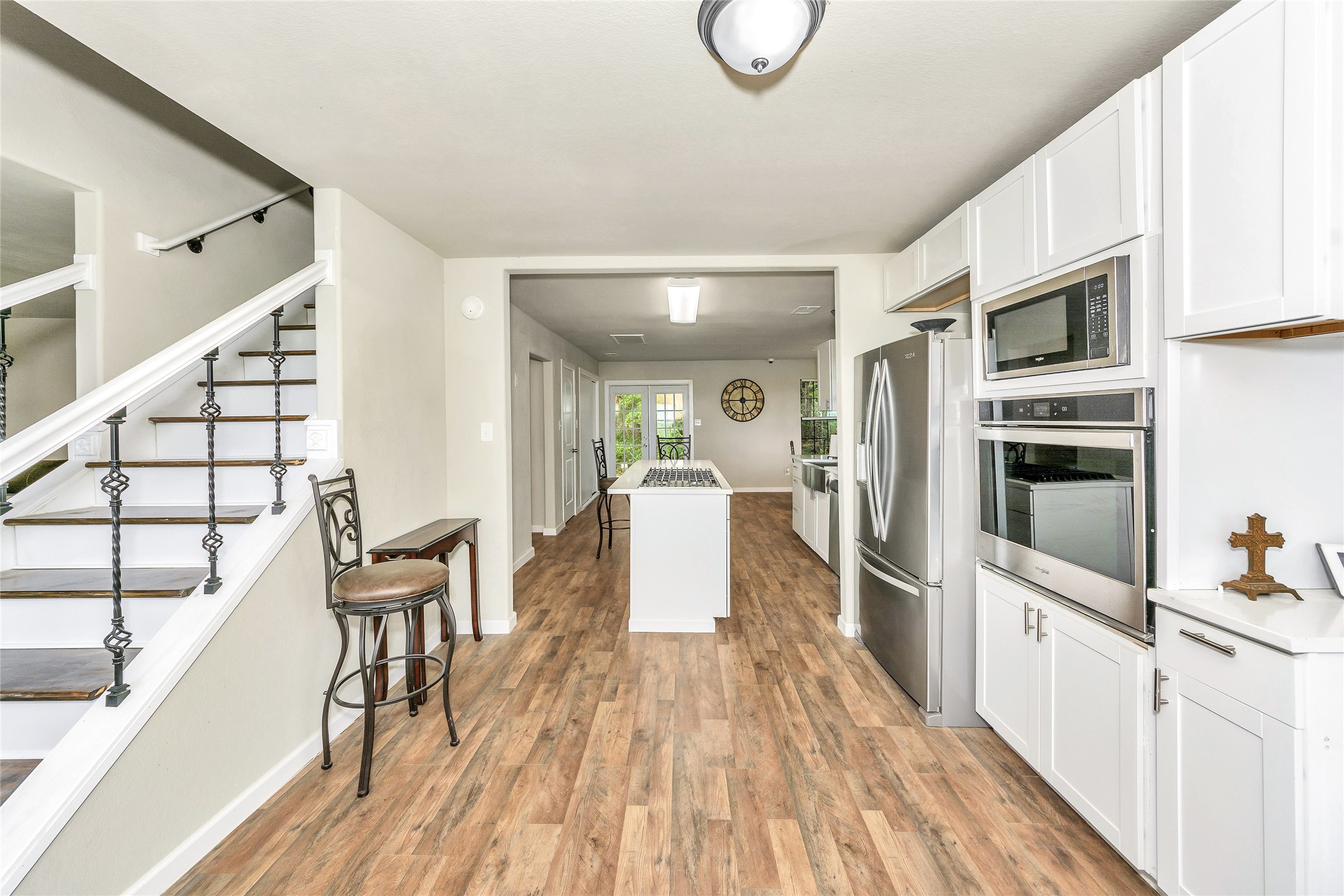 2581 County Road 156 Georgetown, TX 78626 - Photo 11 of 29 a kitchen with stainless steel appliances a microwave a stove and white cabinets with wooden floor