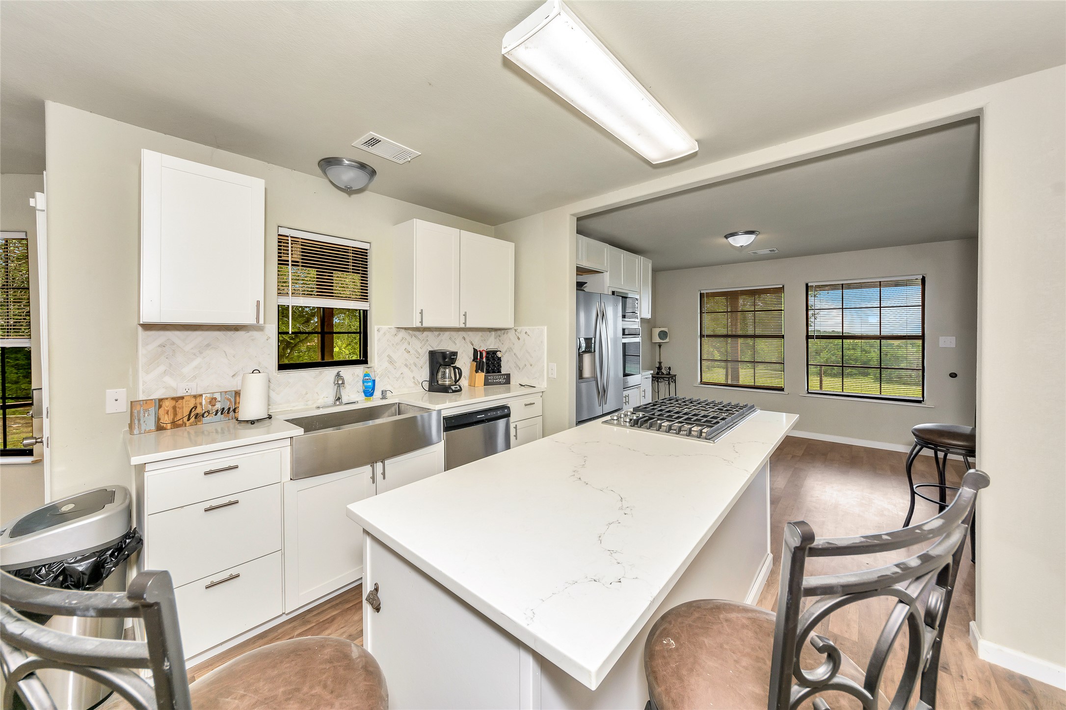 2581 County Road 156 Georgetown, TX 78626 - Photo 12 of 29 a kitchen with white cabinets and stainless steel appliances