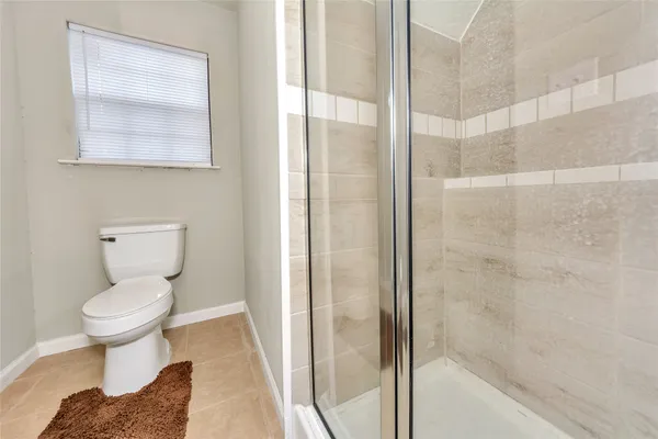 a bathroom with a toilet and a shower