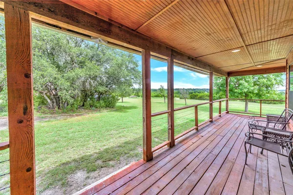 a view of a room with wooden floor and outdoor space