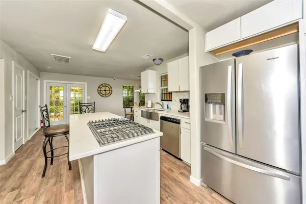 a kitchen with stainless steel appliances granite countertop a refrigerator sink and stove