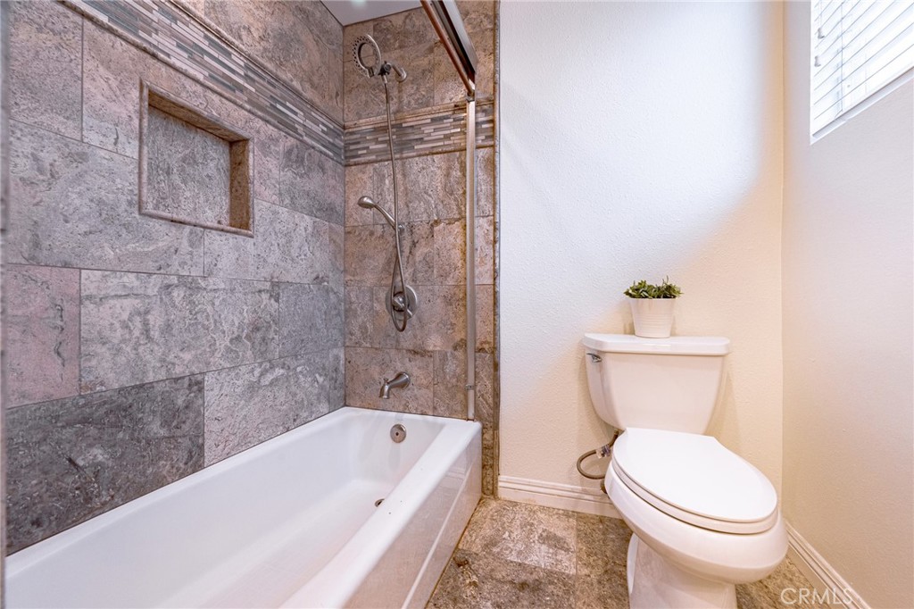 2270 Raleo Avenue Rowland Heights, CA 91748 - Photo 19 of 36 a white toilet sitting next to a bath tub and a shower
