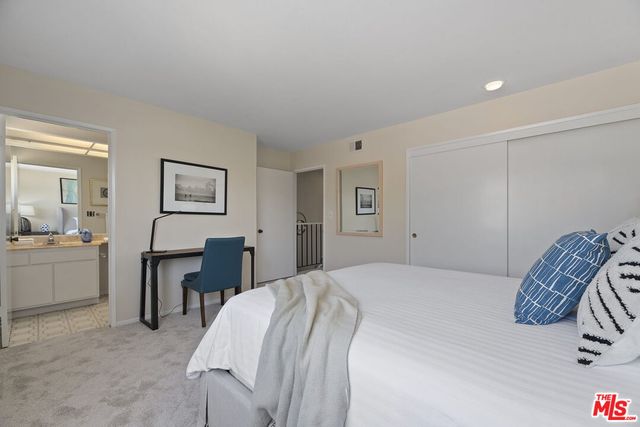 a bedroom with a bed and a chair in it