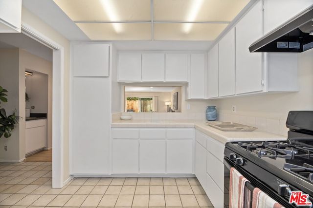 a kitchen with a stove and a refrigerator
