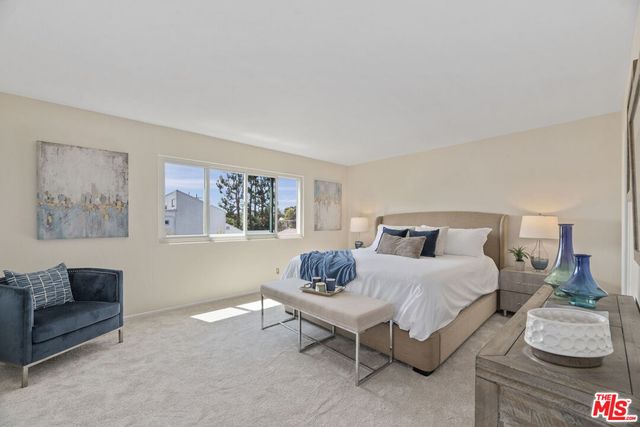 a bedroom with a bed and a couch