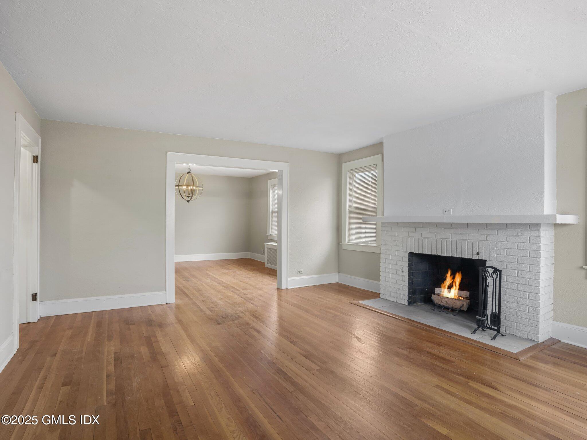 37 High Street, Unit 2 Greenwich, CT 06830 - Photo 6 of 23 an empty room with wooden floor fireplace and cabinet