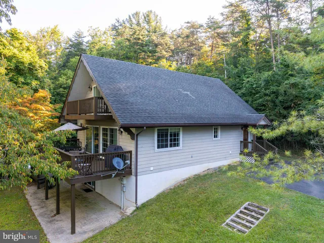 a view of a house with a yard and sitting area