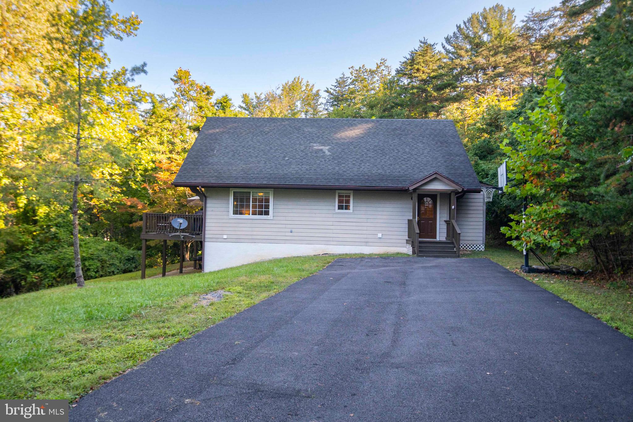 125 Fritzel Way Basye, VA 22842 - Photo 16 of 72 a front view of a house with a garden and yard