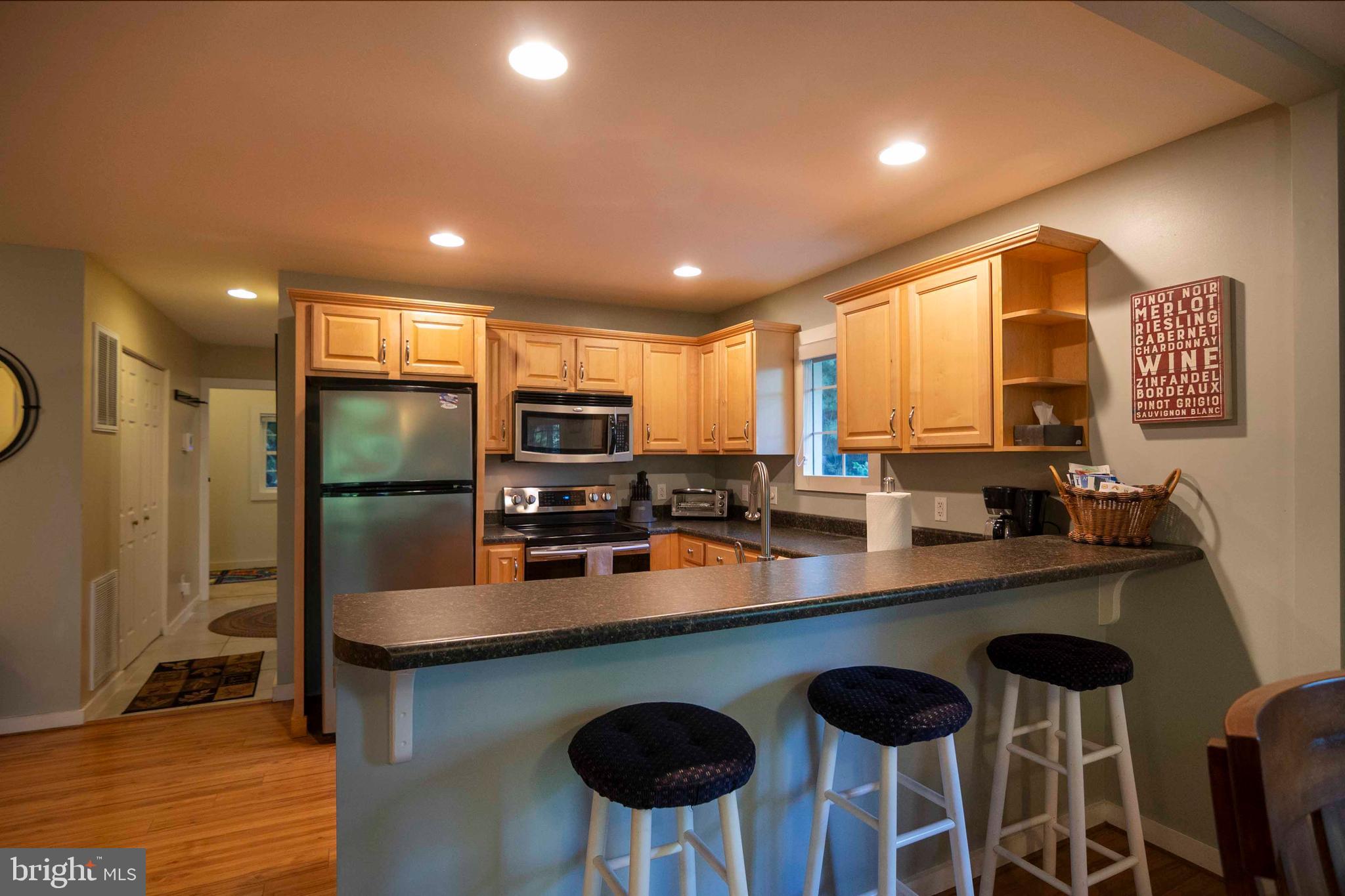 125 Fritzel Way Basye, VA 22842 - Photo 29 of 72 a kitchen with stainless steel appliances a sink a stove a refrigerator cabinets and dining table