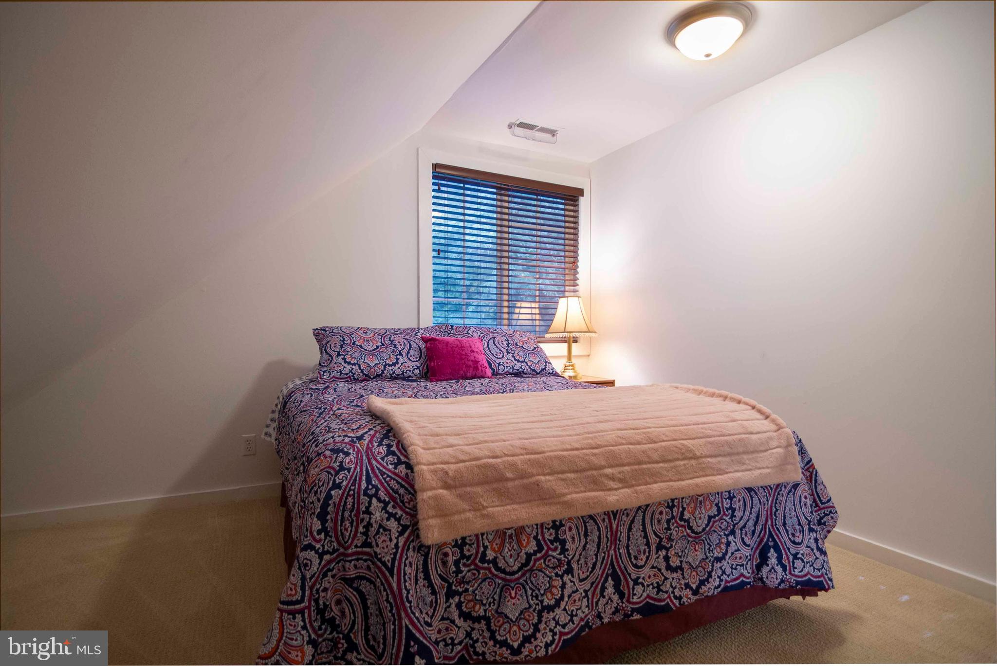 125 Fritzel Way Basye, VA 22842 - Photo 49 of 72 a bedroom with a bed a window and a chandelier