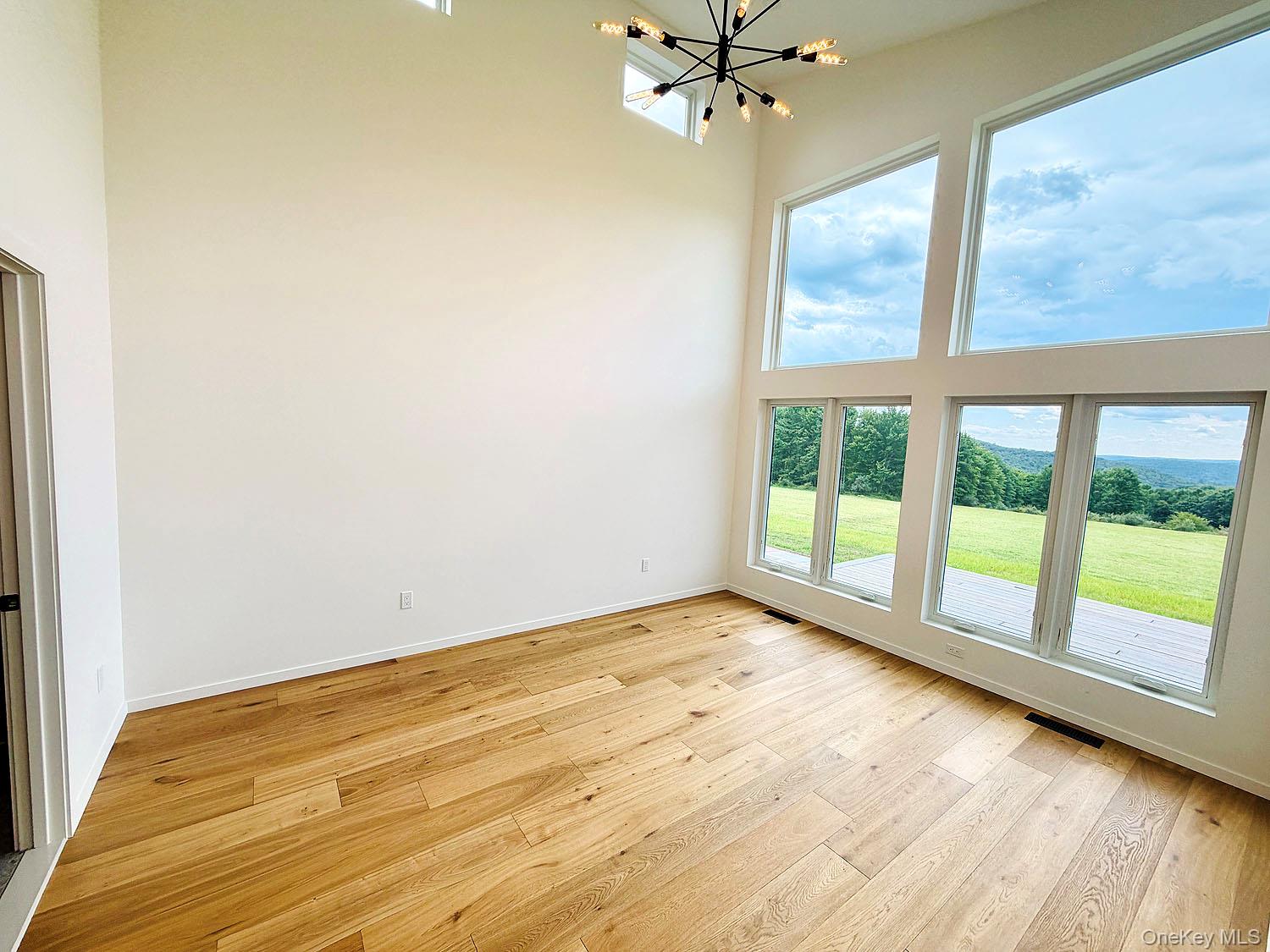 199 Henderson Road Hankins, NY 12741 - Photo 12 of 28 Washed with light. Big windows take advantage of the long-range views!