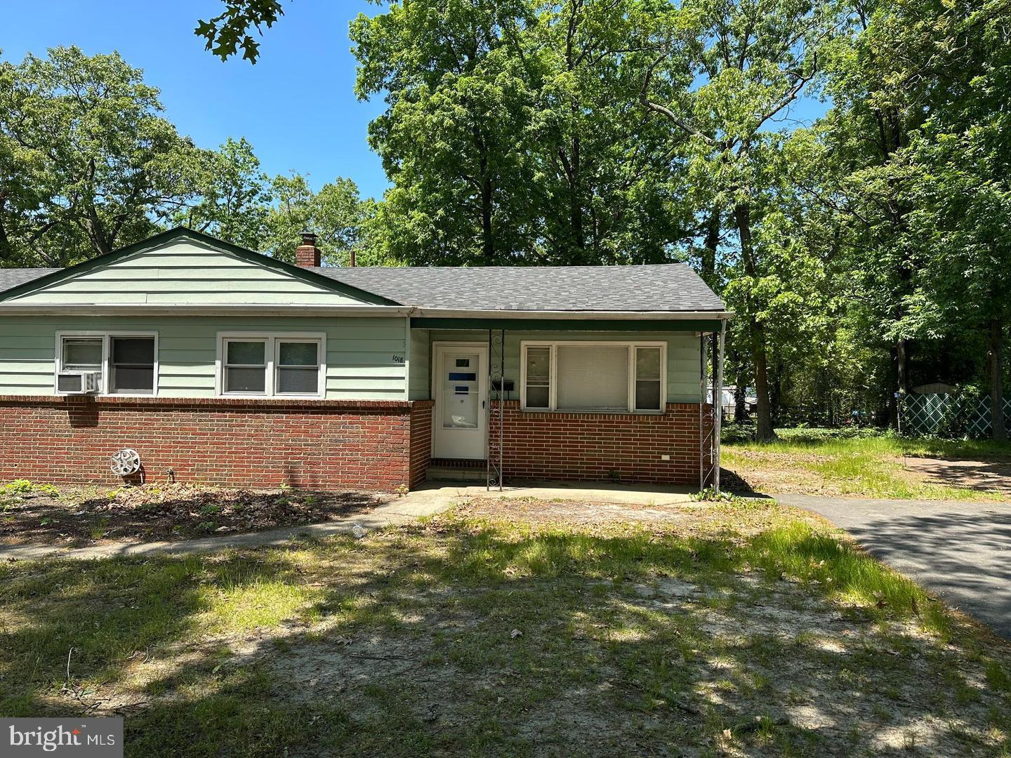 a front view of a house with yard and green space