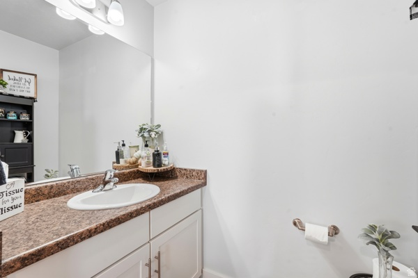 391 South 440th Street West Preston, ID 83263 - Photo 14 of 28 Bathroom vanity featuring a white oval sink, chrome faucet, and a large mirror