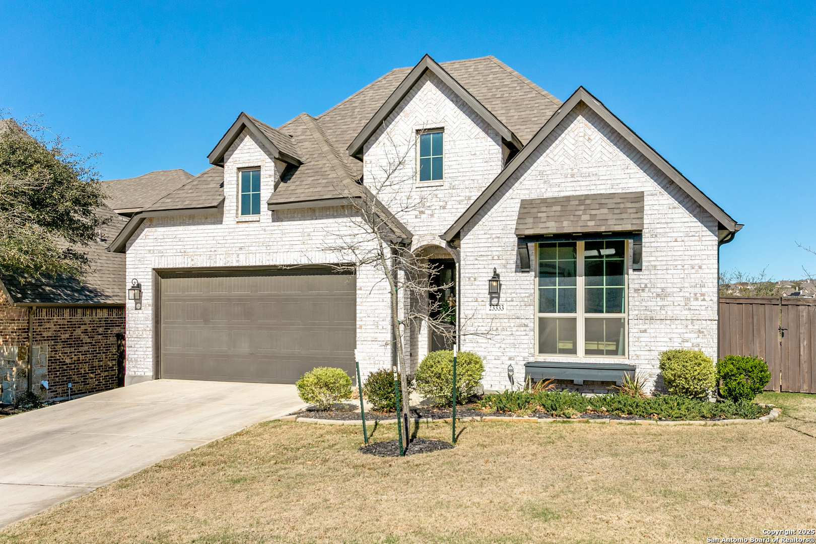 23333 Emerald Pass San Antonio, TX 78258 - Photo 1 of 1 a front view of a house with a yard and garage