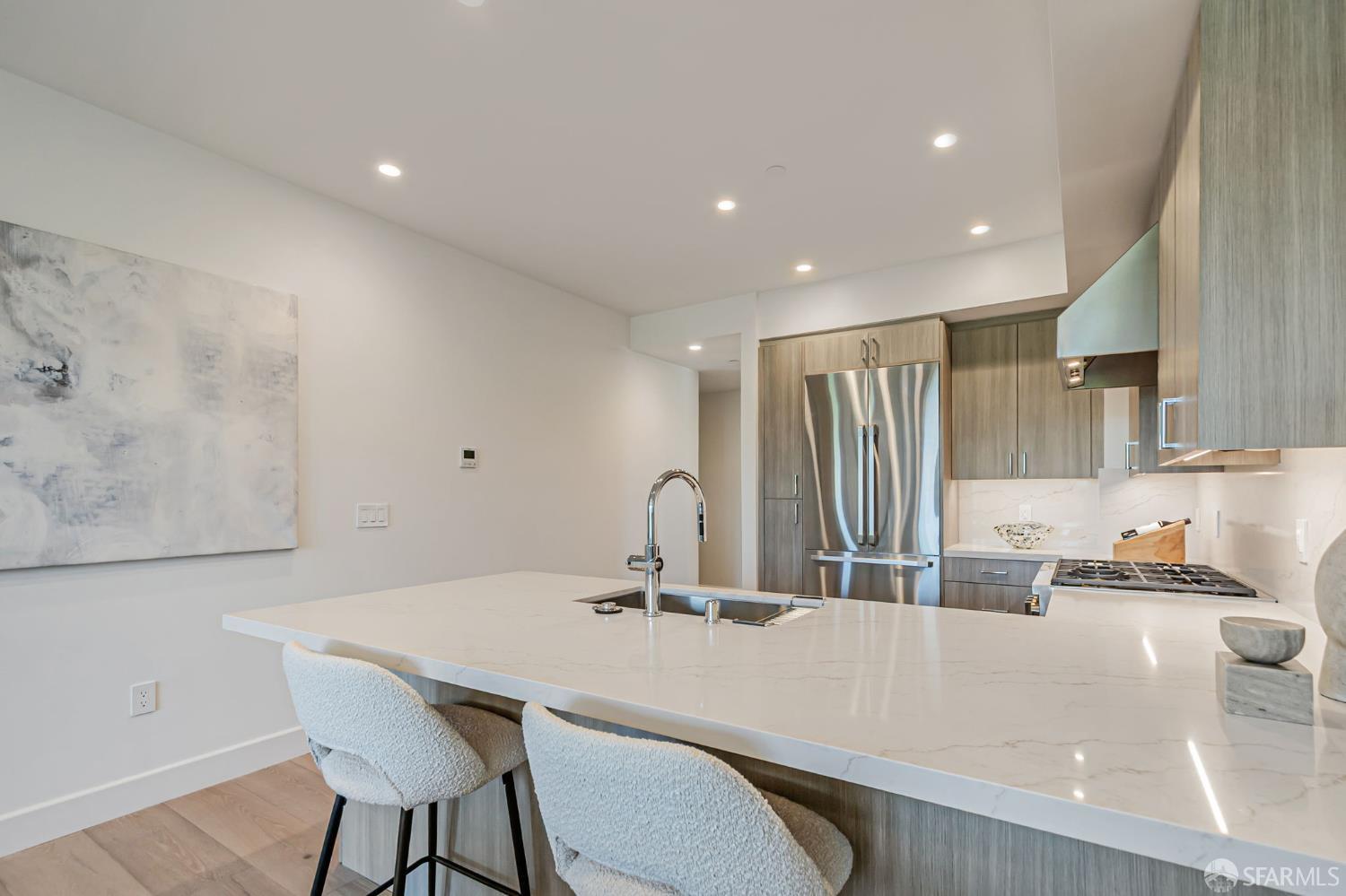 425 1st Street, Unit 36 Los Altos, CA 94022 - Photo 6 of 42 a kitchen with kitchen island a stove a sink a refrigerator and chairs