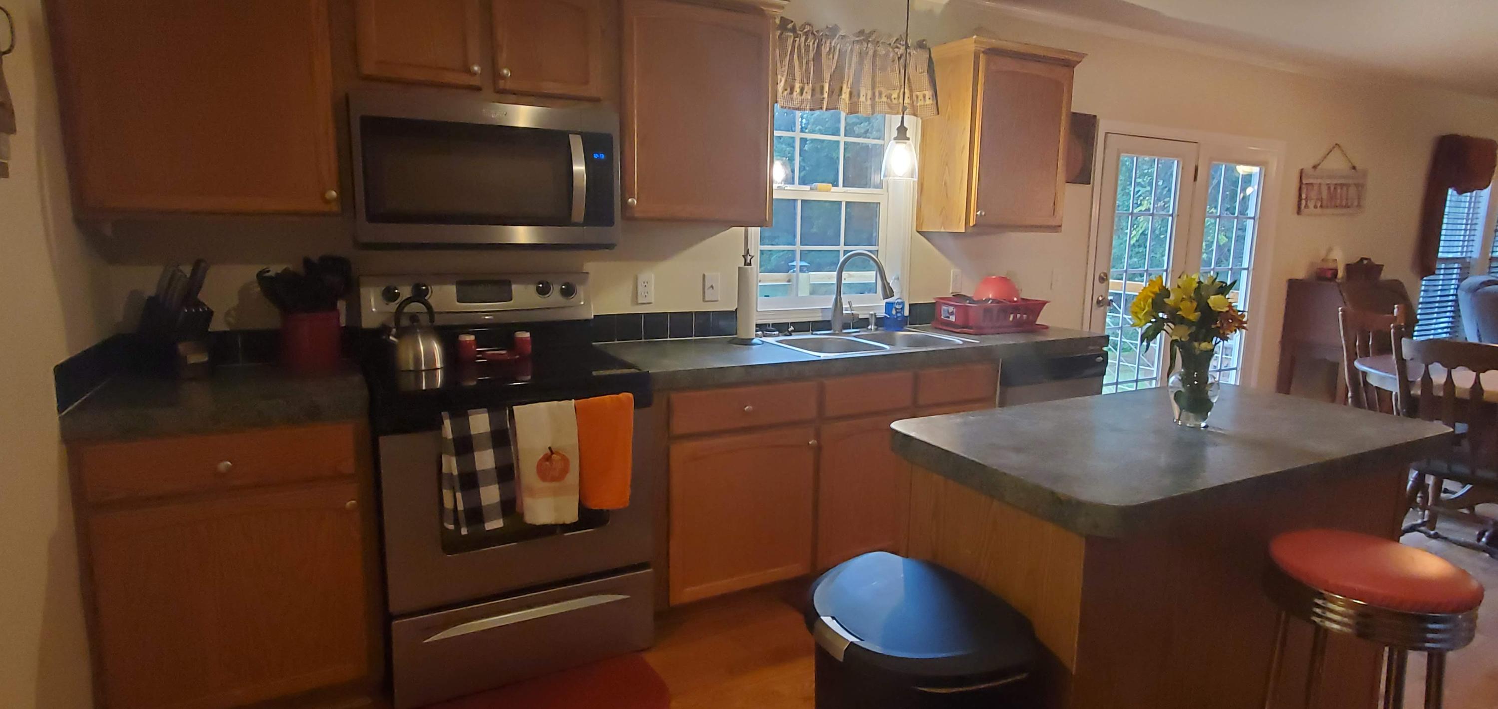 160 Northridge Road Hardy, VA 24101 - Photo 8 of 42 a kitchen with stainless steel appliances granite countertop a sink a microwave cabinets and a dining table