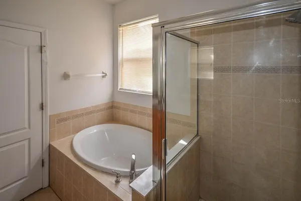 a bathroom with a glass shower door