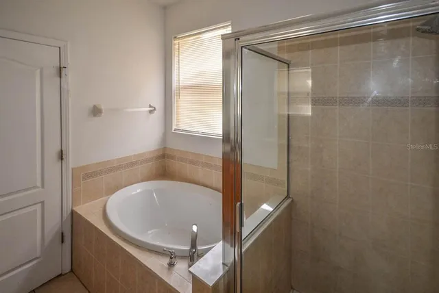 a bathroom with a glass shower door