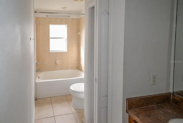 a bath room with a toilet and a bath tub
