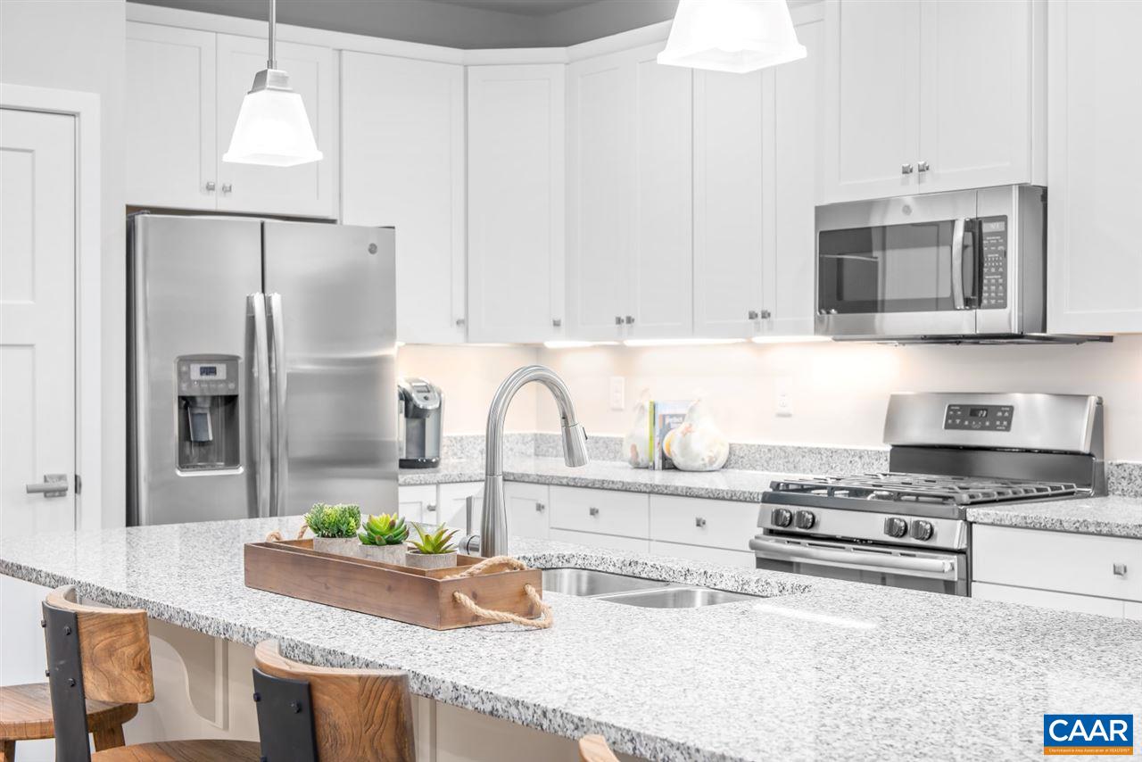 386 Winding Road Keswick, VA 22947 - Photo 8 of 20 a kitchen with granite countertop a stove a sink and a refrigerator