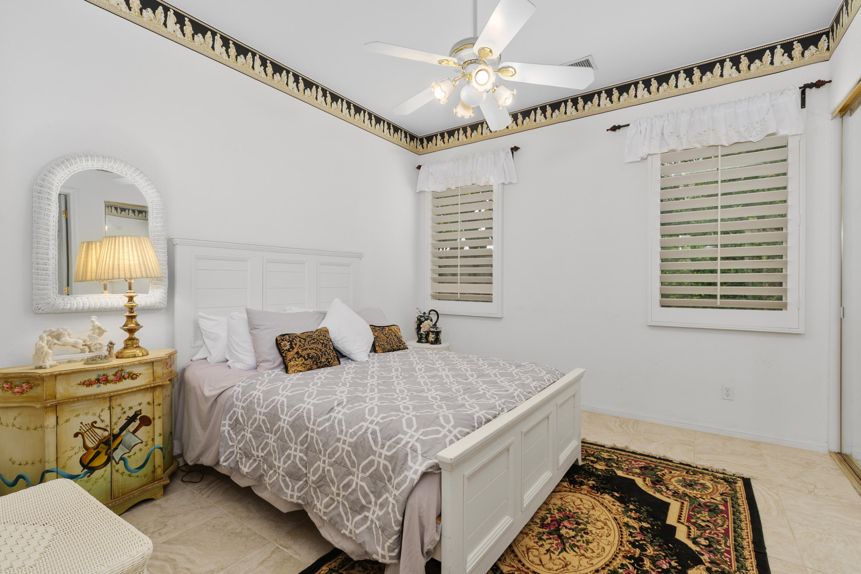 2 Othello Court Rancho Mirage, CA 92270 - Photo 22 of 45 a bedroom with a bed and a chandelier