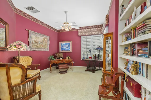 a spacious bedroom with a bed and a chandelier