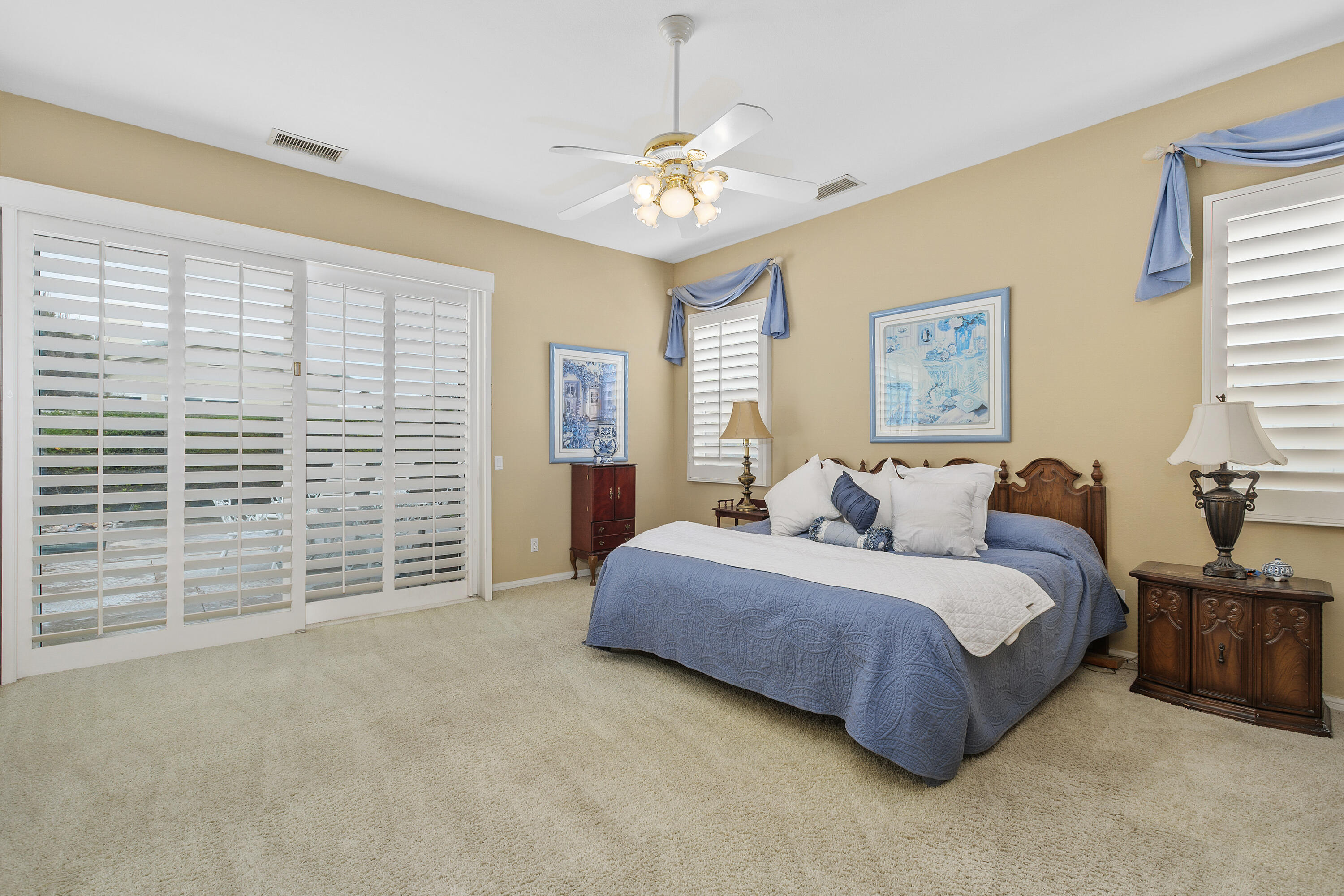 2 Othello Court Rancho Mirage, CA 92270 - Photo 26 of 45 a spacious bedroom with a bed and a chandelier