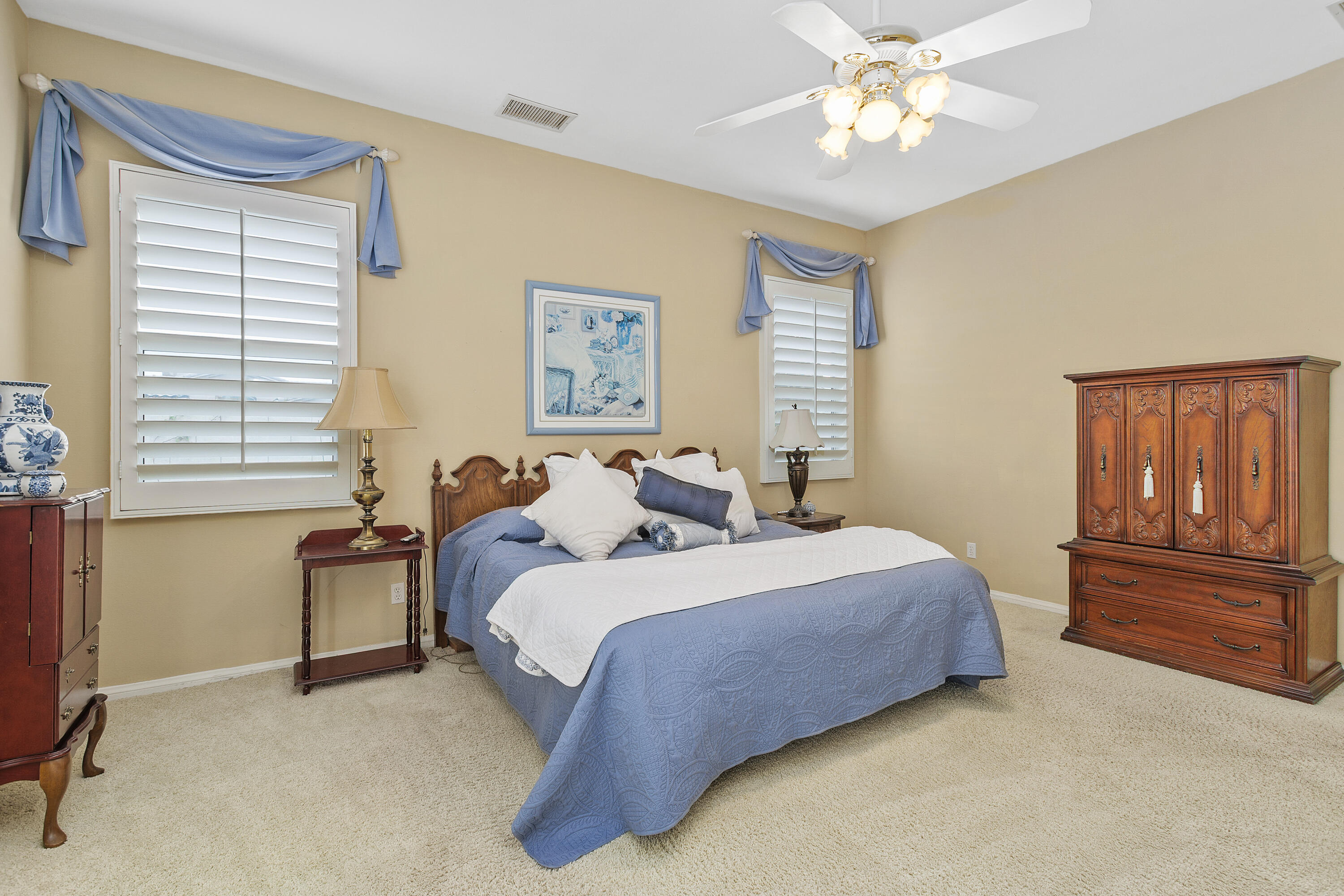 2 Othello Court Rancho Mirage, CA 92270 - Photo 28 of 45 a bedroom with a bed and a chandelier