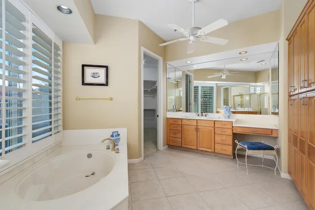 a bathroom with a granite countertop sink a bathtub and a shower