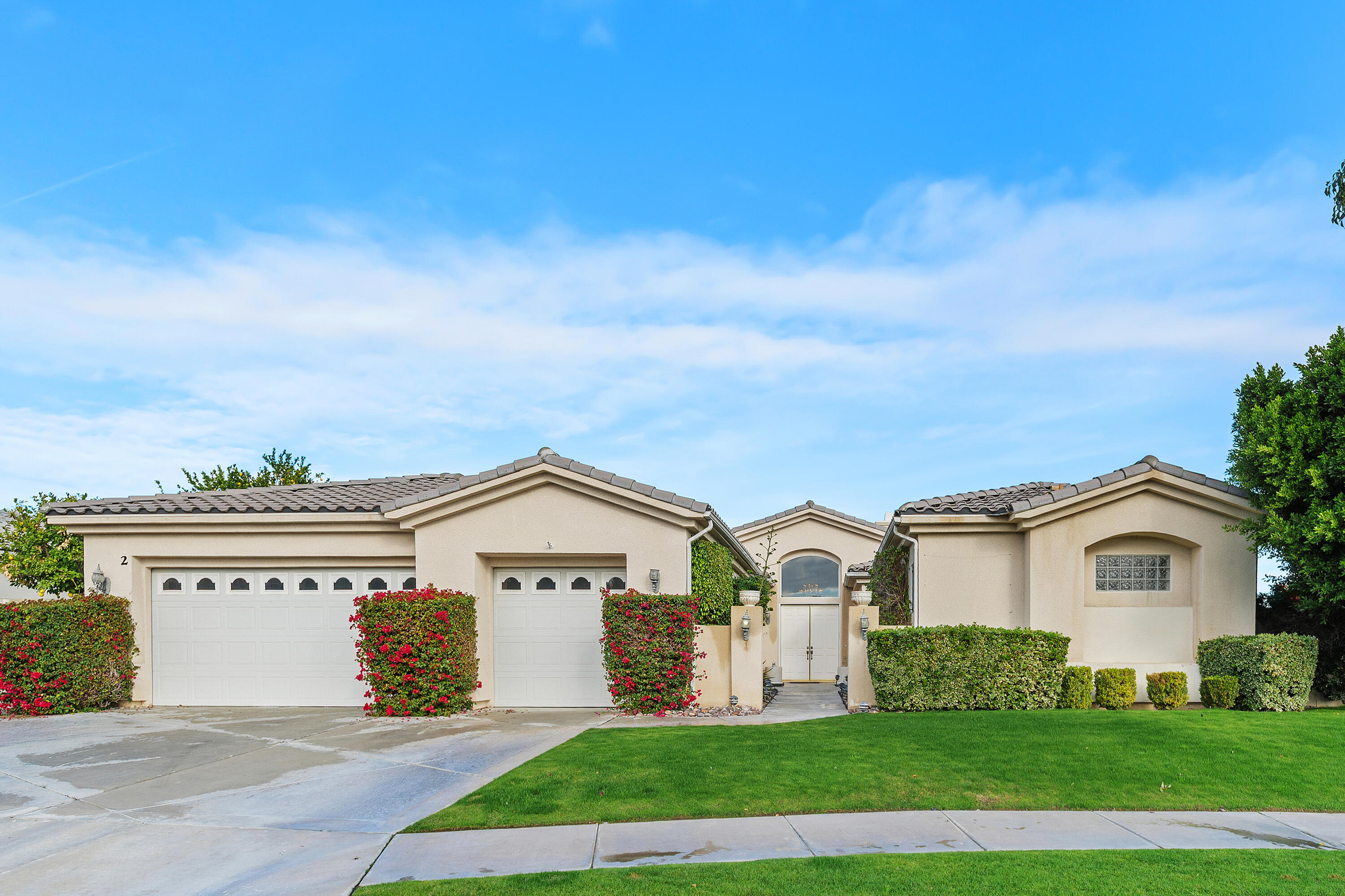 2 Othello Court Rancho Mirage, CA 92270 - Photo 4 of 45 a front view of a house with a yard and garage