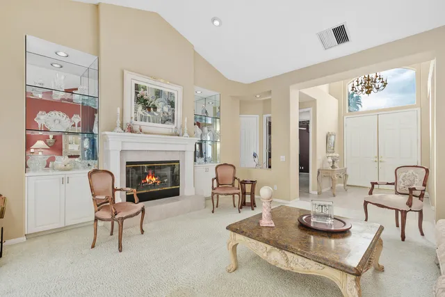 a view of a dining room with furniture and chandelier