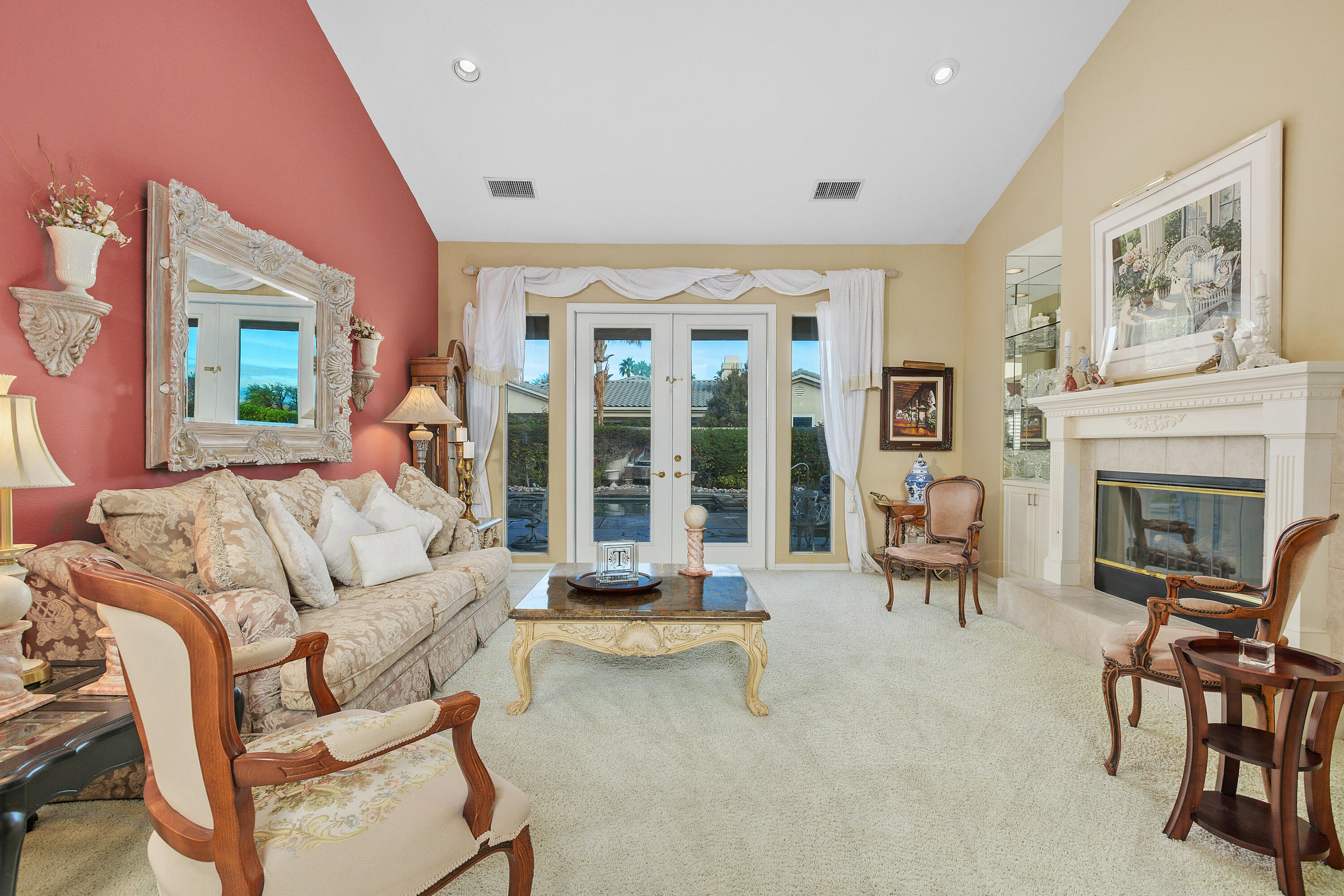 2 Othello Court Rancho Mirage, CA 92270 - Photo 10 of 45 a living room with furniture a fireplace and a large window